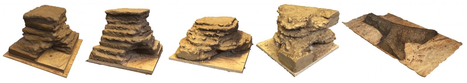 Five finished experimental rammed-earth prototypes, including layered towers, a branching body and a Y-shaped element.